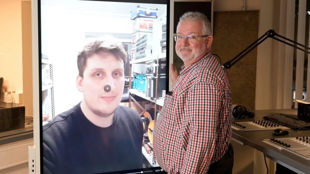Weihnachtsvideo Andreas Guballa Display Andreas Guballa steht am Touchscreen und wünscht frohe Feiertage